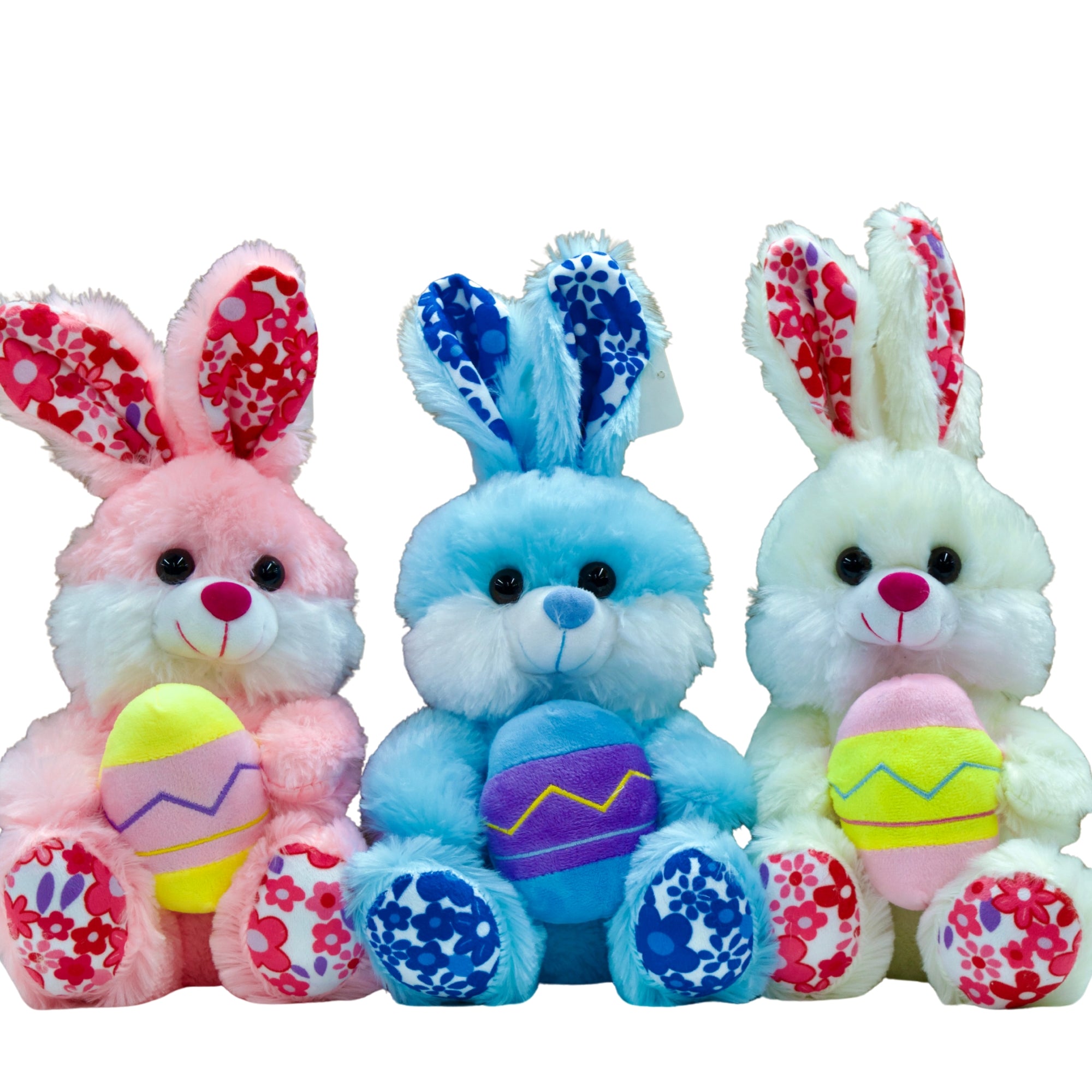 Three colorful plush toys shaped like bunnies with Easter eggs on a white background
