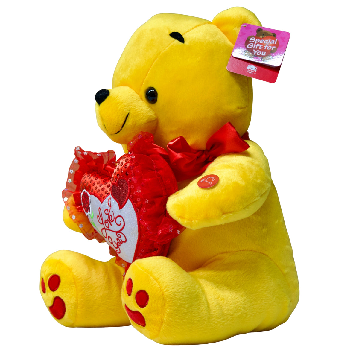 Yellow teddy bear holding a red heart with a tag on a white background